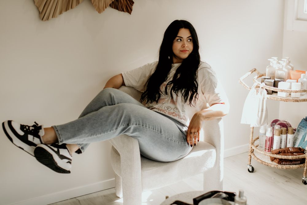 Casual indoor lifestyle portrait with sneakers and minimalist white furniture.