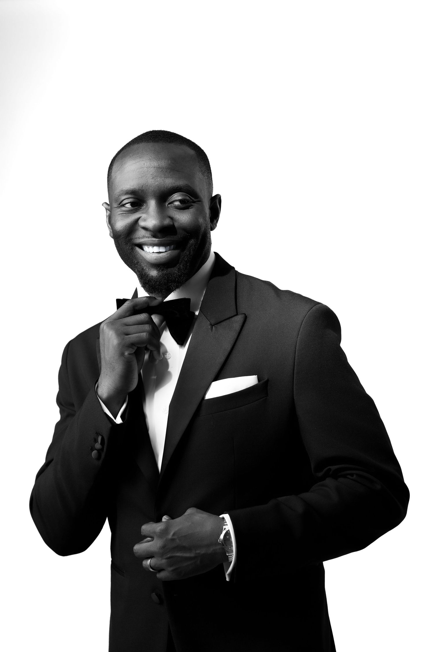 Black and white photo series showing a person in a suit making different expressive poses and gestures.