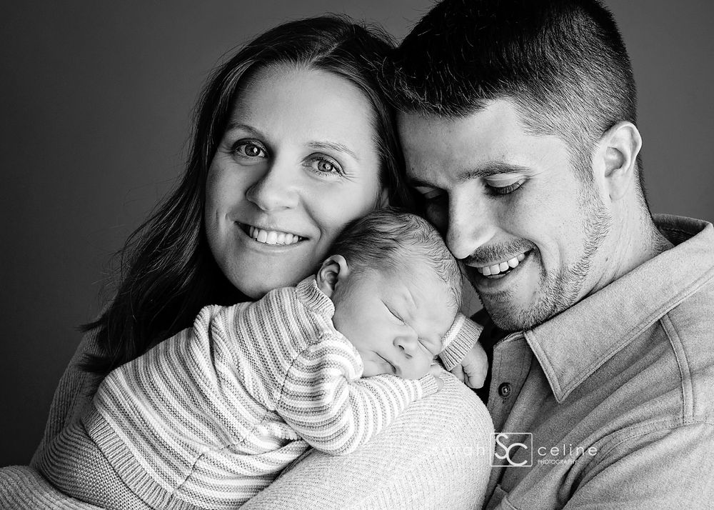 A series of intimate black and white family portraits showing tender moments between parents and their newborn baby.
