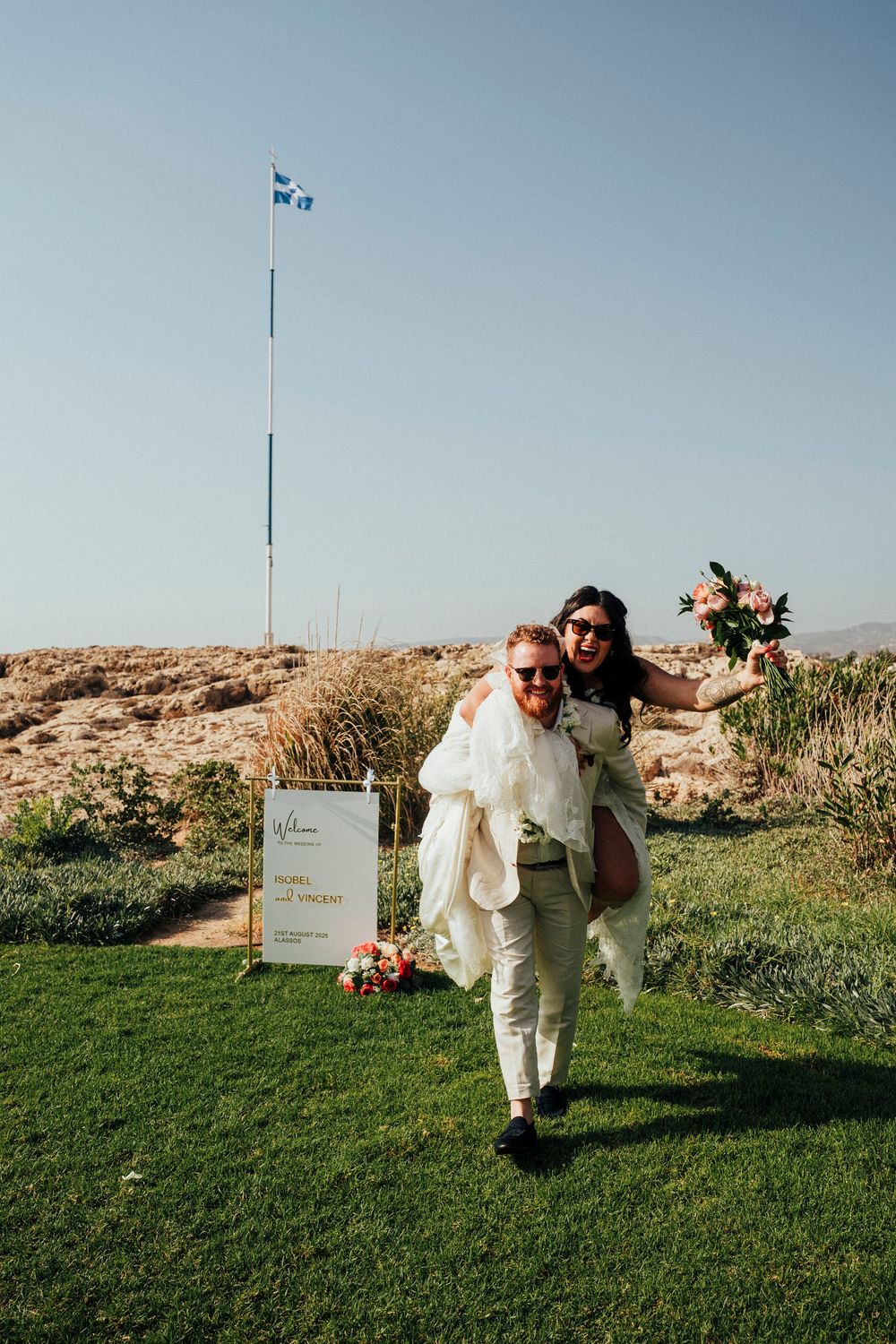 A series of wedding photos showing someone in a white suit dancing and posing playfully on a grassy hilltop.