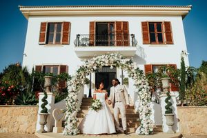 A series of wedding venue photos showing white columns, stone walls, and floral decorations at an elegant outdoor location.