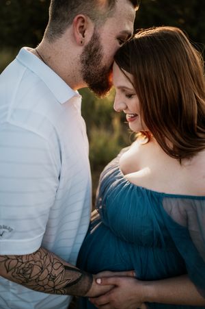 A romantic couple in white and blue embraces in a series of intimate outdoor portrait photographs at sunset.
