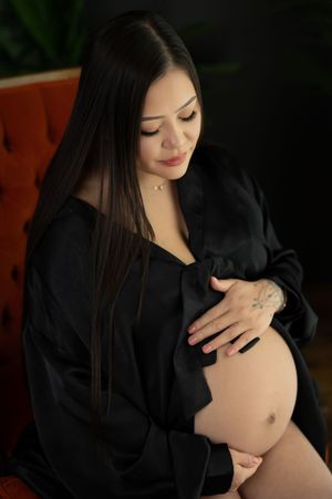 A series of intimate maternity photos showing a pregnant belly in a black robe against a dark background.
