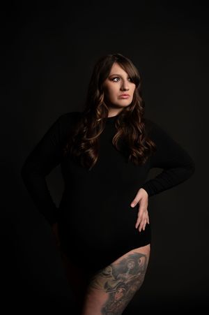A series of moody portrait photographs showing someone in black clothing against a dark background displaying a tattoo.
