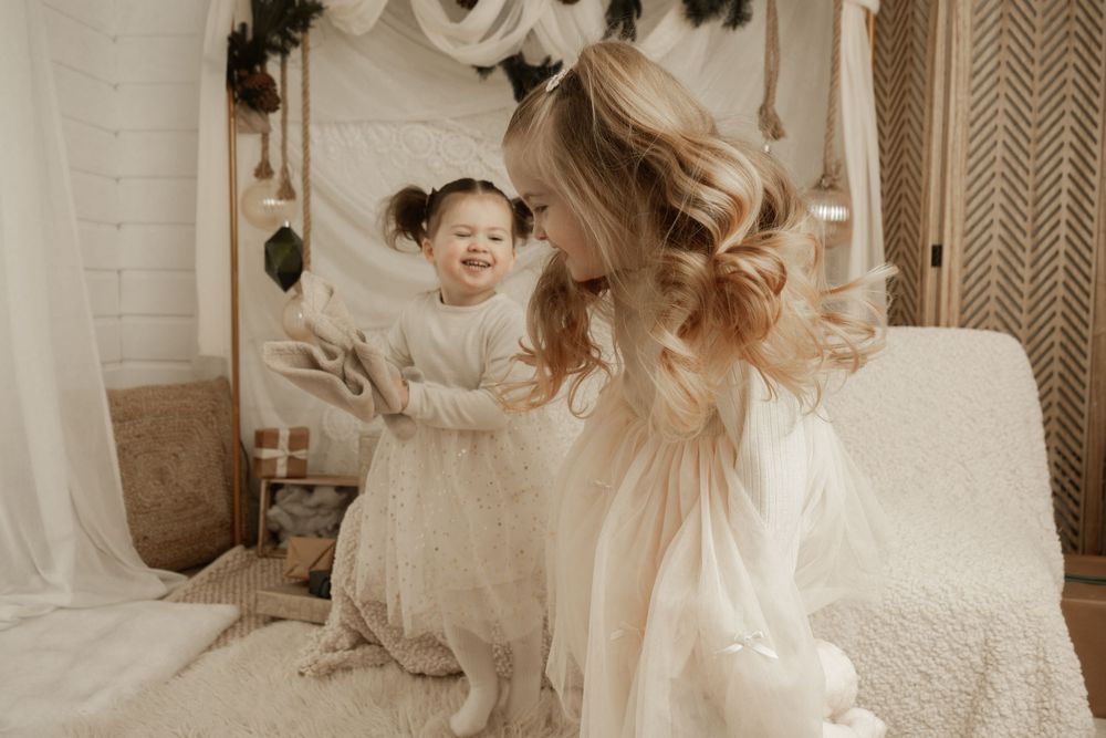A collage of intimate wedding moments showing laughter and joy in a light, airy setting with white decor.