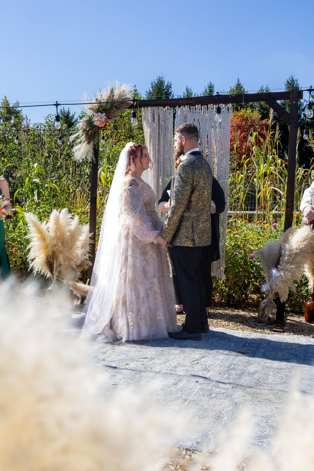 A couple shares their first dance outdoors on a snowy winter day with a dramatic flowing dress creating a magical scene.