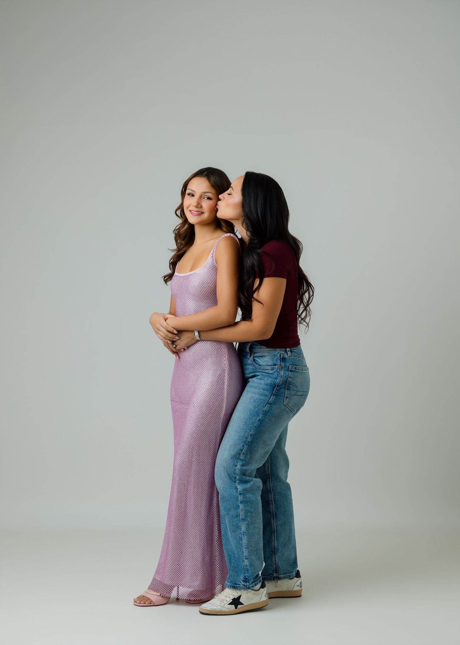 Mother and daughter posing together during a studio birthday session