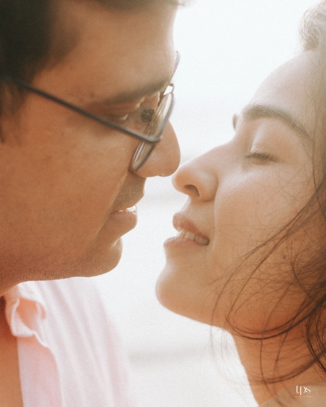 Close-up profile shots of a couple about to kiss in soft lighting.