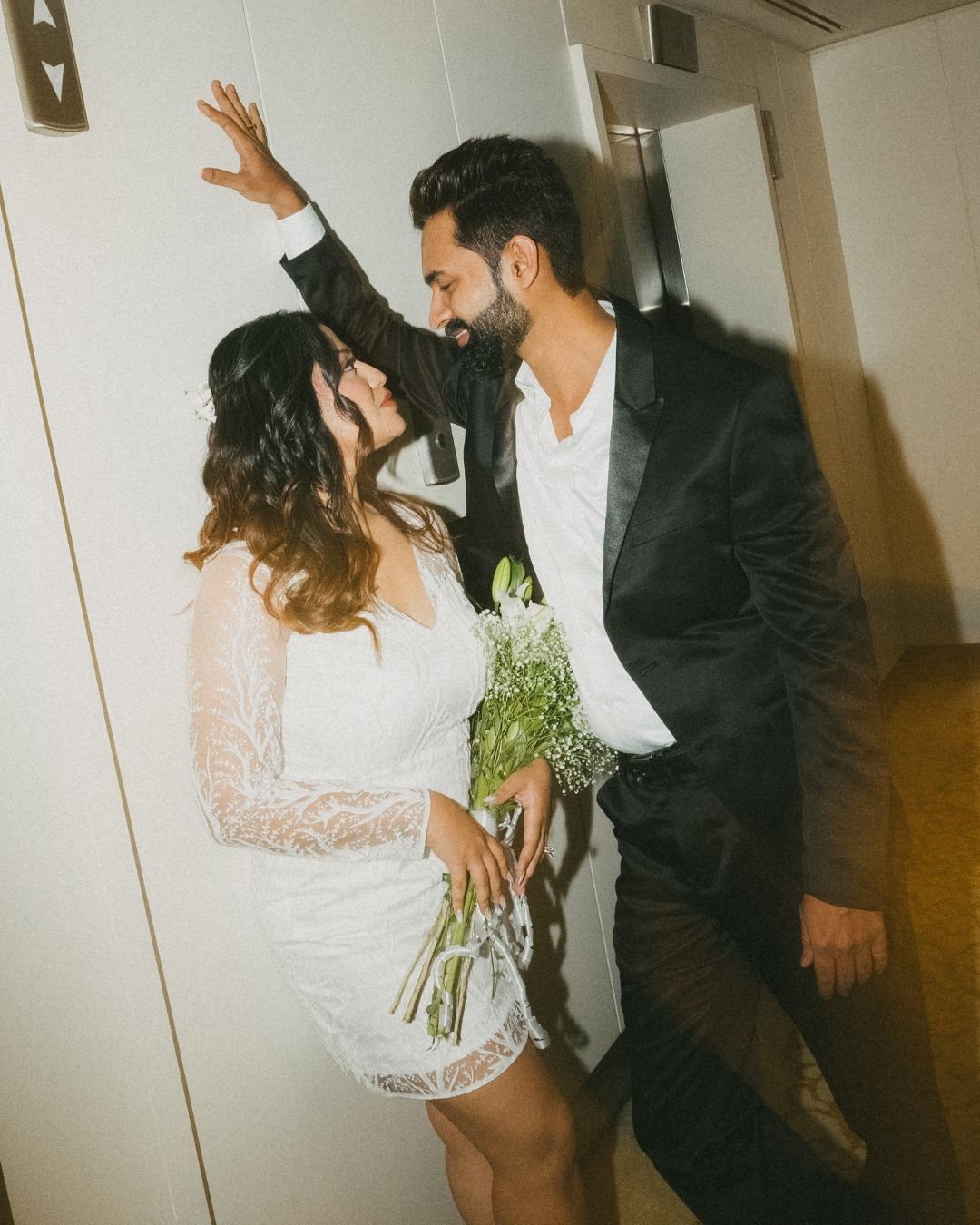 Artistic wedding photos showing tender moments between newlyweds against a light background.