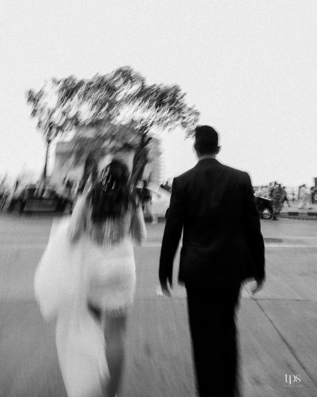 Artistic motion blur wedding photography of couple walking together.