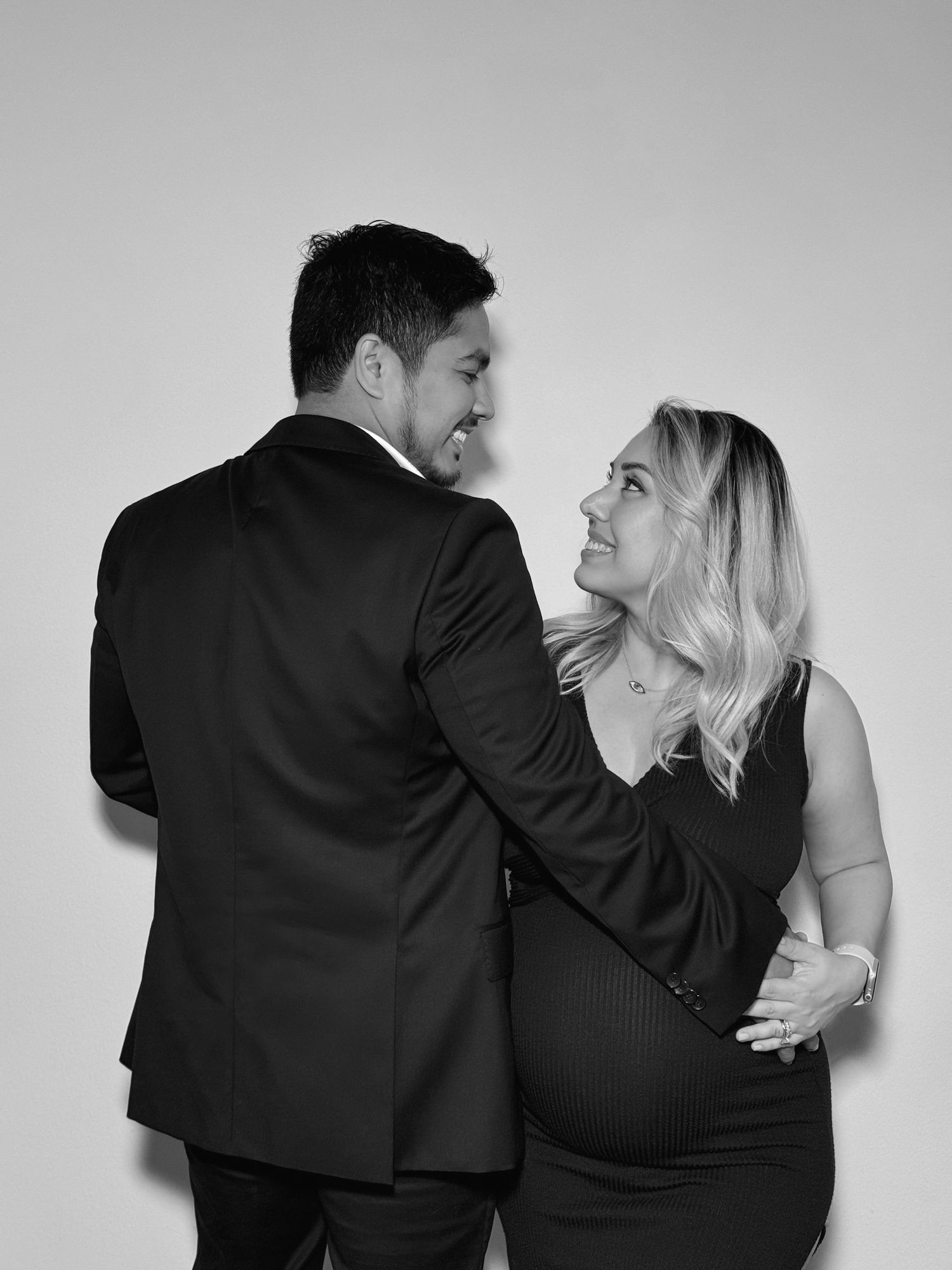 Romantic couple poses together in black and white artistic portrait series.