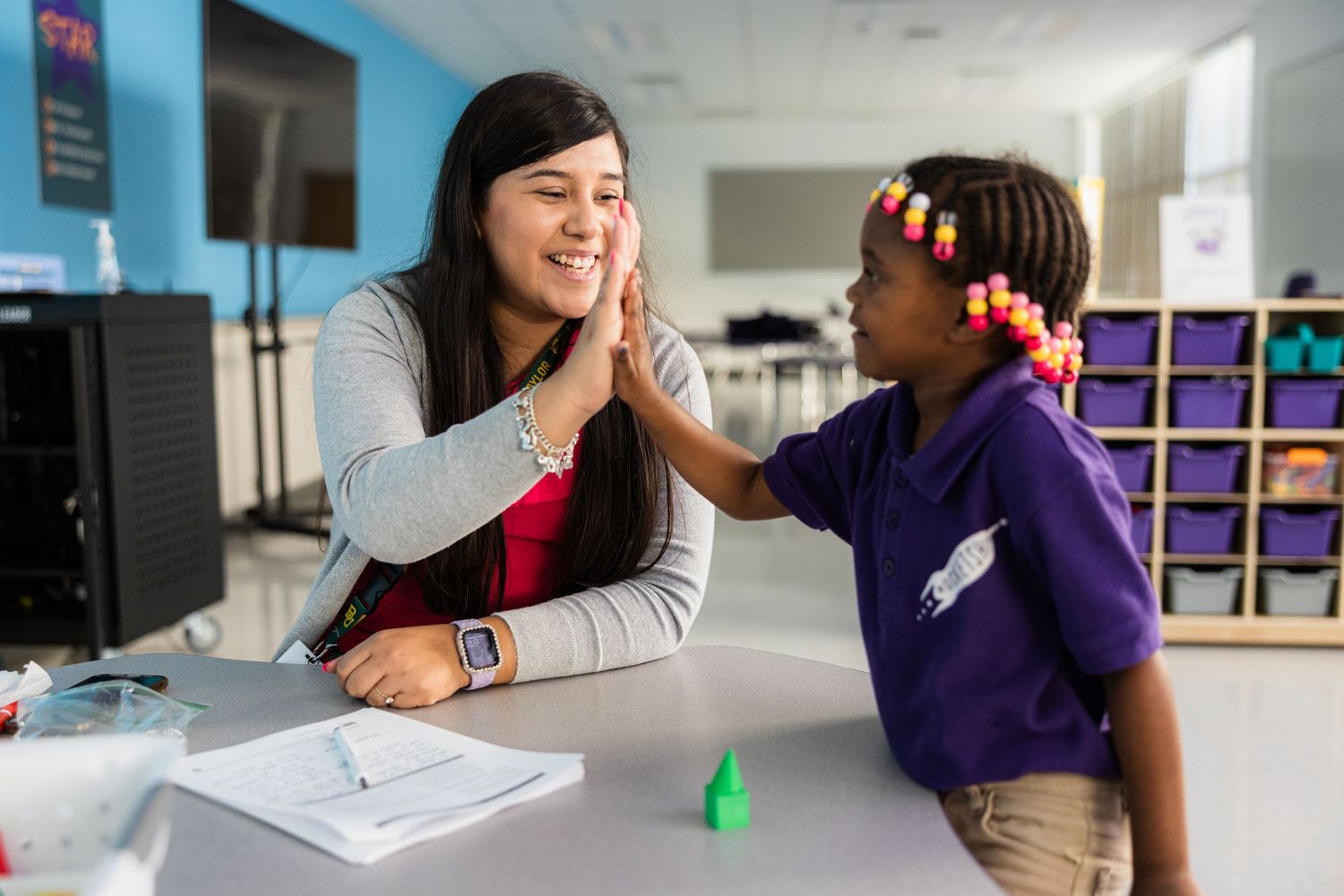 Students participating in interactive learning activities in a modern classroom environment.