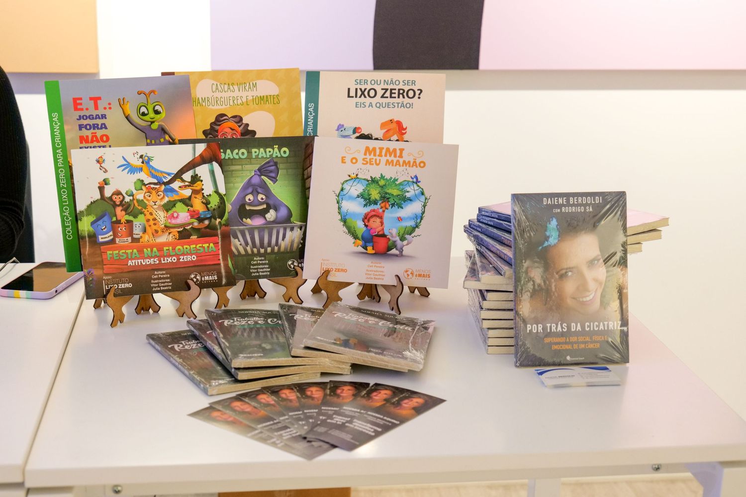 Collection of colorful children's books and educational materials displayed on a white table.