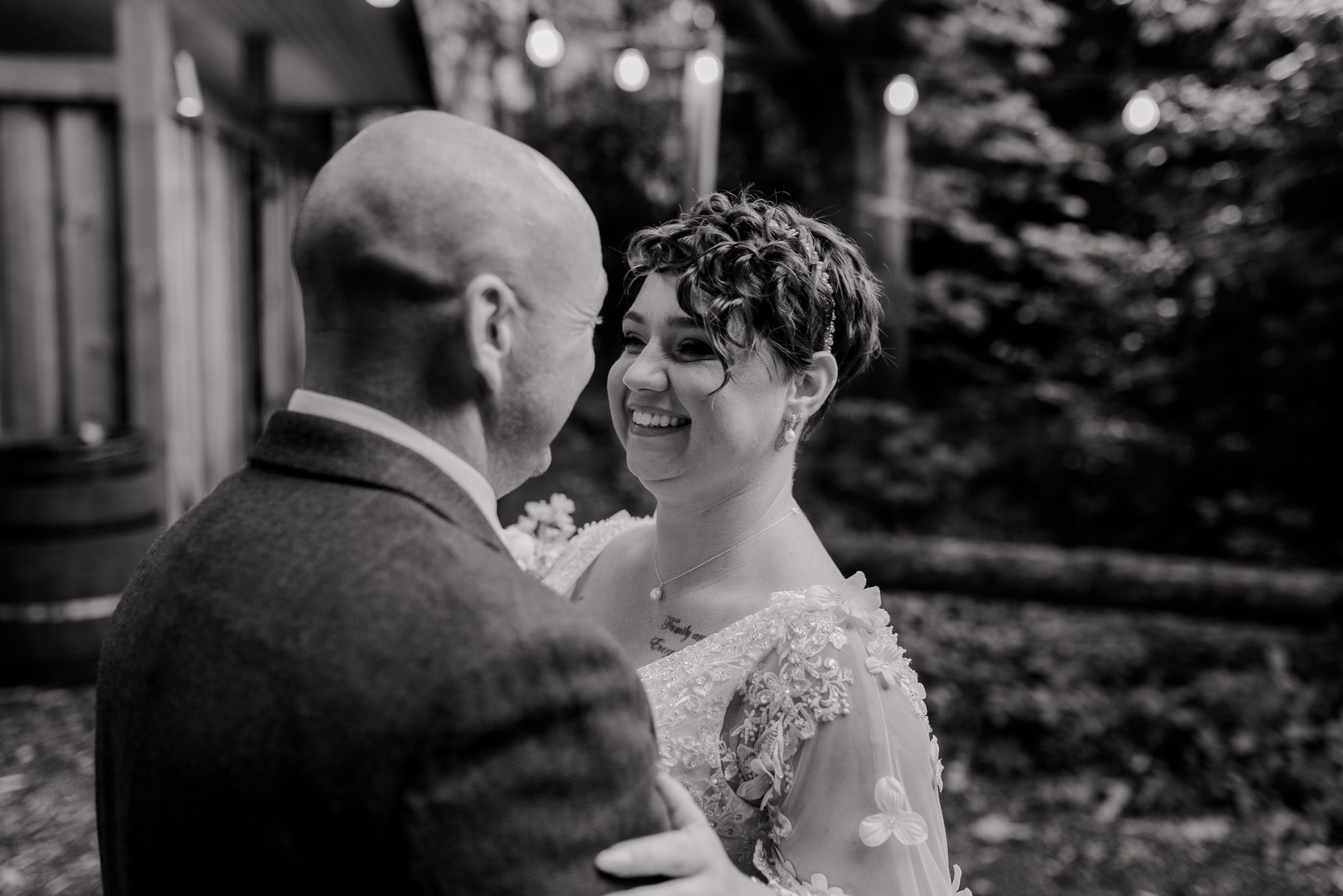 A tender moment captured between two people during an outdoor wedding celebration.