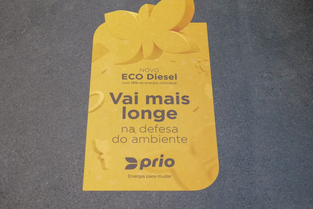 Yellow Prio ECO Diesel promotional floor sticker reading Vai mais longe na defesa do ambiente.