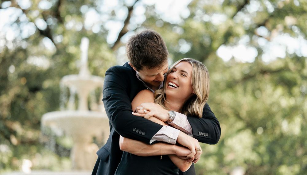 Couple embracing during outdoor engagement session – playful Texas couple photography