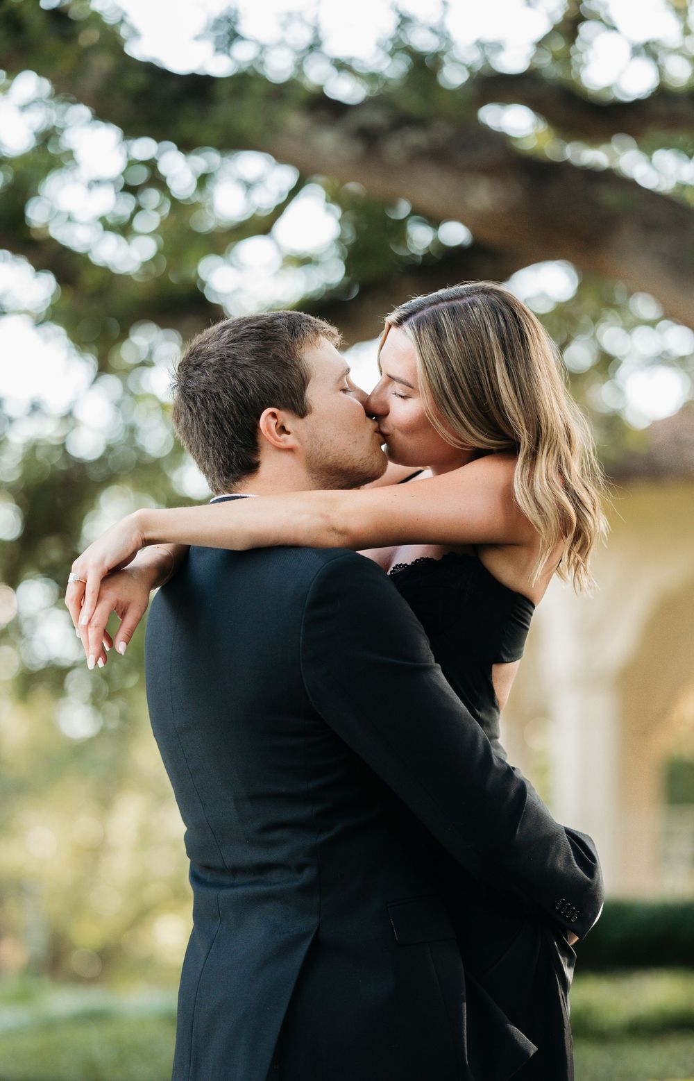 Bride and groom dancing under oak trees – candid romantic moment in DFW area