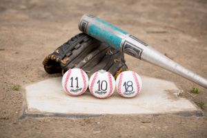 Baseball equipment with numbered bottle caps arranged on home plate.