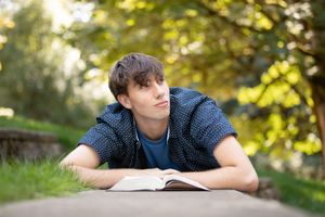 A series of outdoor portrait photos showing someone in casual attire against a sunlit natural background with trees.