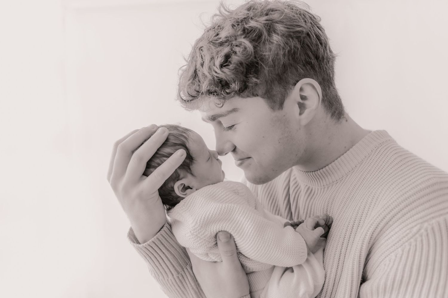 Black and white photo series showing a person in a sweater expressing various emotions and poses.
