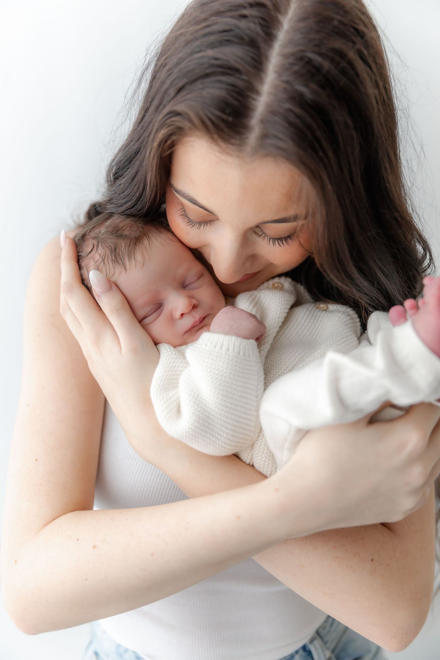A tender moment captured in a series of photos showing someone embracing a soft white pillow against a light background.