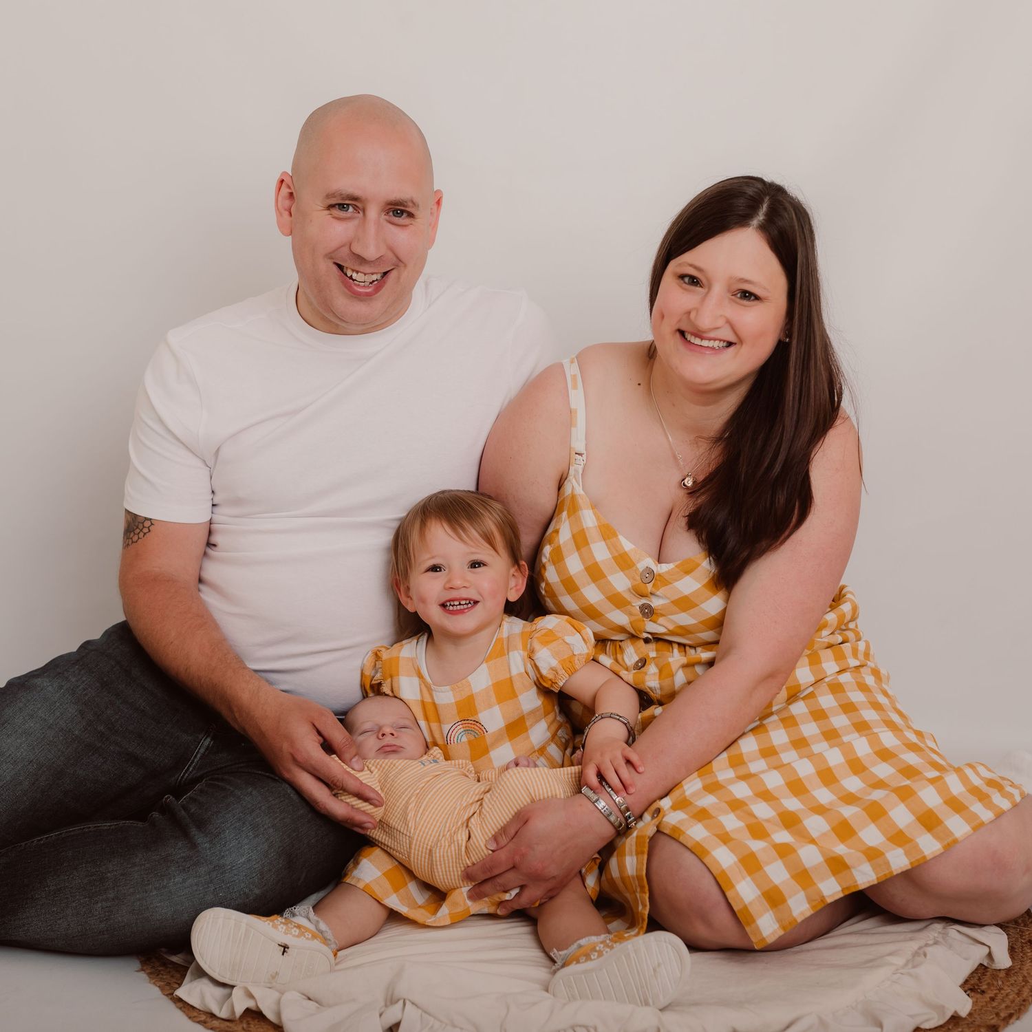 Family portrait series with coordinating yellow gingham outfits against a neutral background. Photographer. Hull. East Yorkshire. Photograph