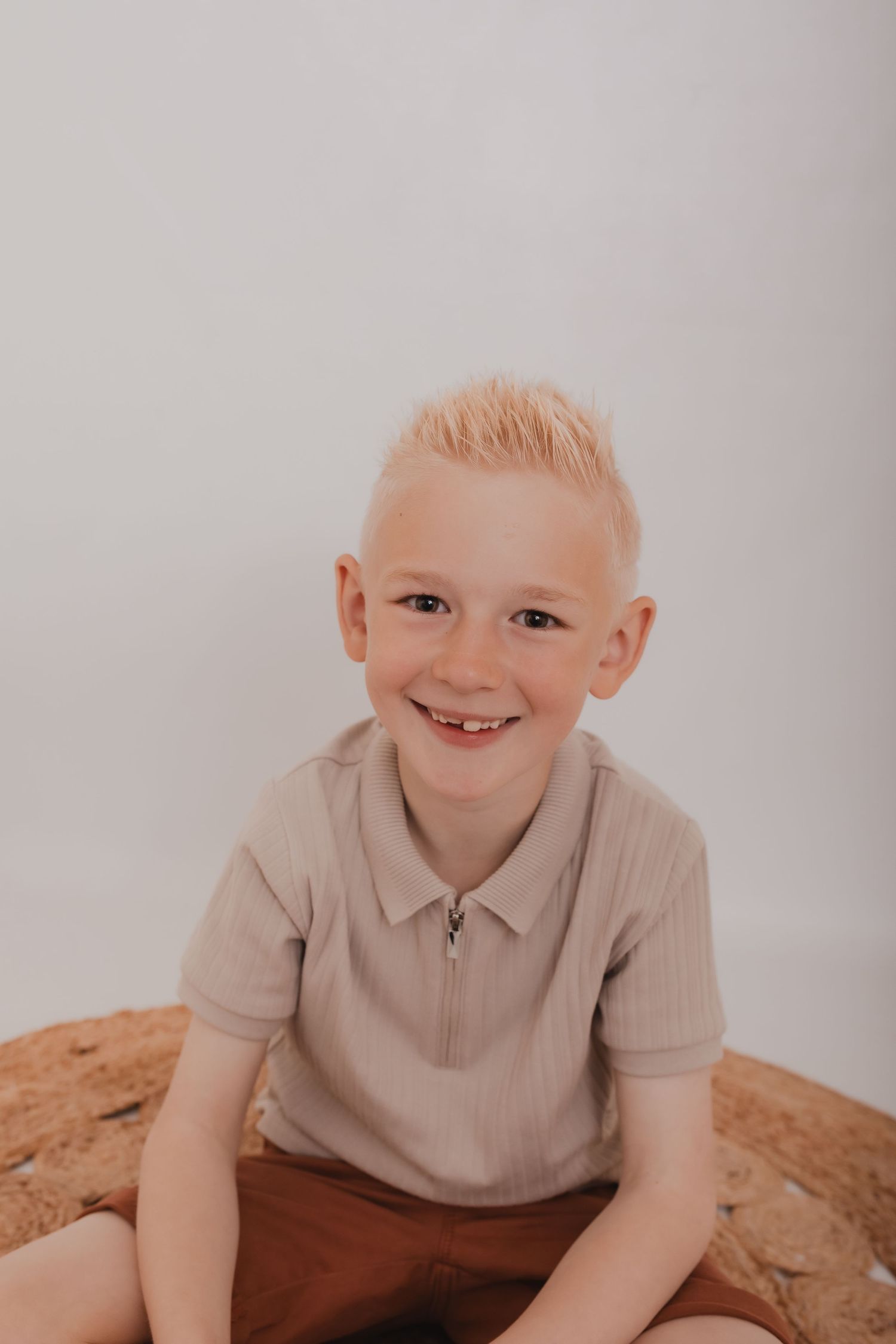 Studio portraits of a child in beige clothing against white background. Photographer. Hull. East Yorkshire. Photography
