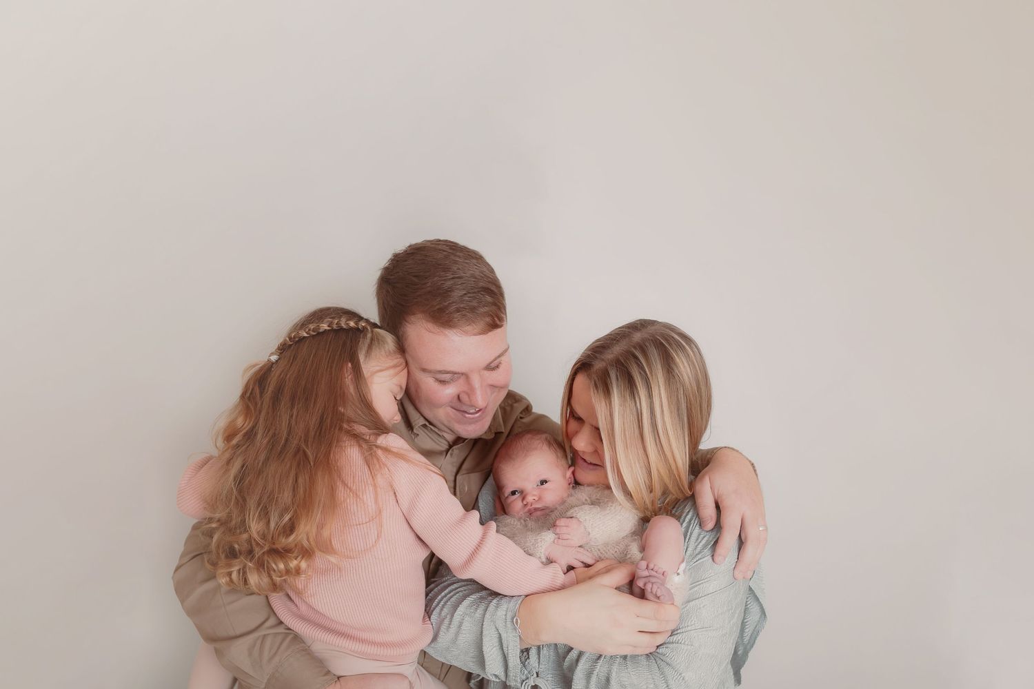 Intimate family portrait session with parents and children in neutral tones against light background. Photographer. Hull. East Yorkshire.