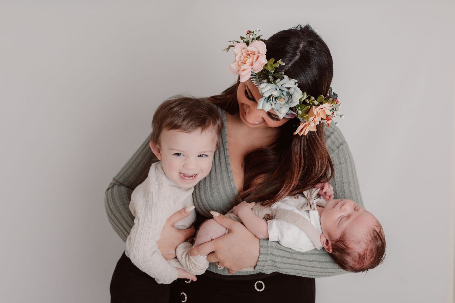 Family portrait session showing intimate moments between mother and children against grey backdrop. Photographer. Hull. East Yorkshire. Phot