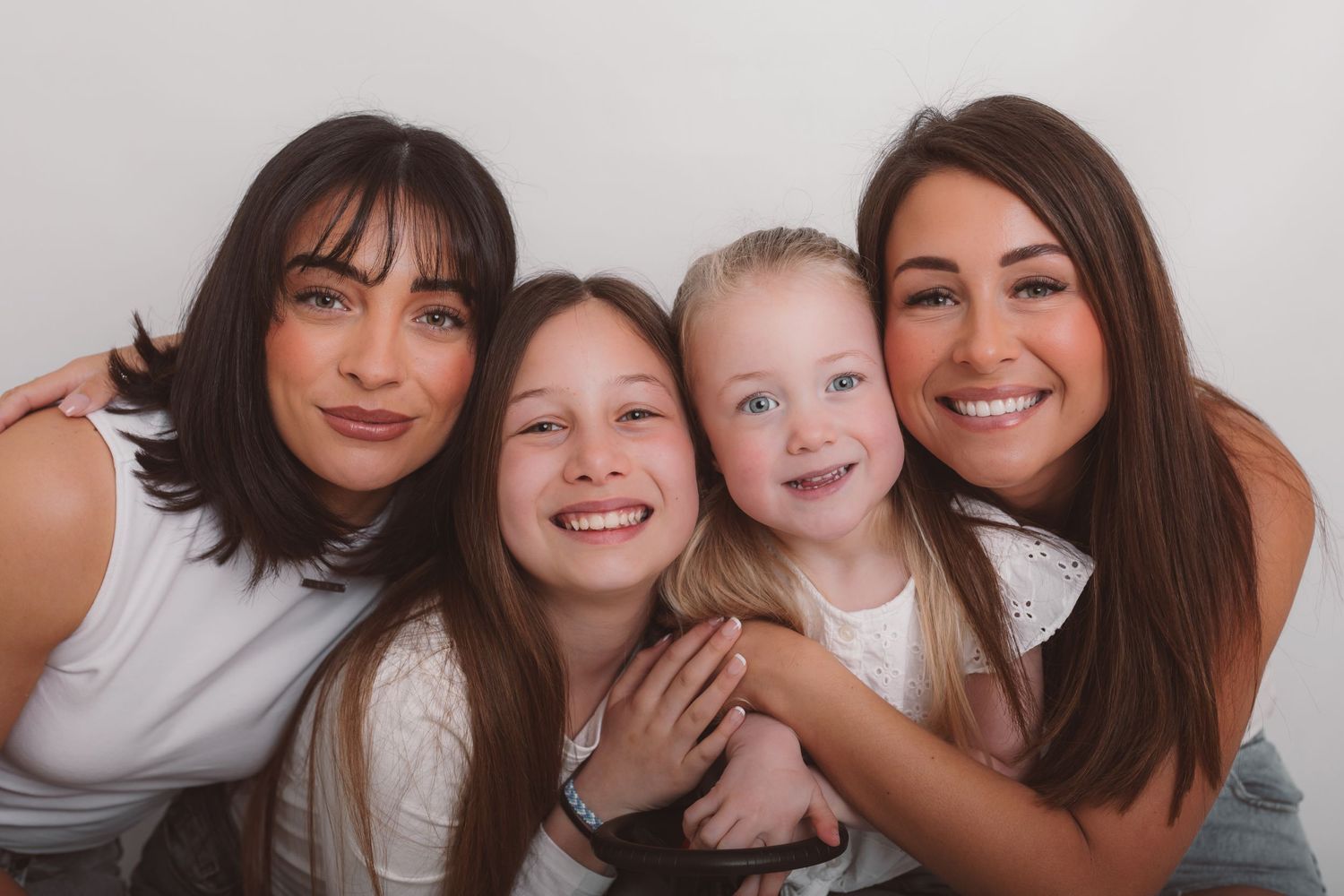 Casual family photo session with everyone wearing white and sharing joyful moments together. Photographer. Hull. East Yorkshire. Photography