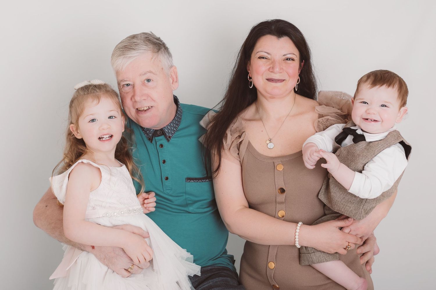 Family photo session against white backdrop wearing coordinated neutral tones. Photographer. Hull. East Yorkshire. Photography