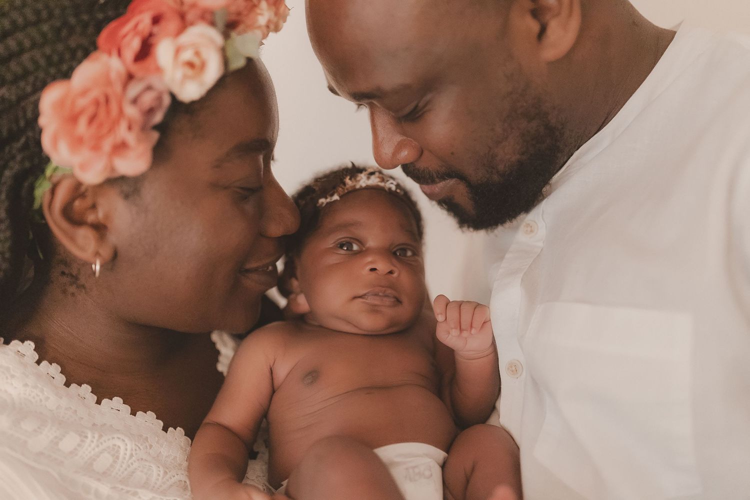 Loving family portraits with coral floral accents and white attire. Photographer. Hull. East Yorkshire. Photography