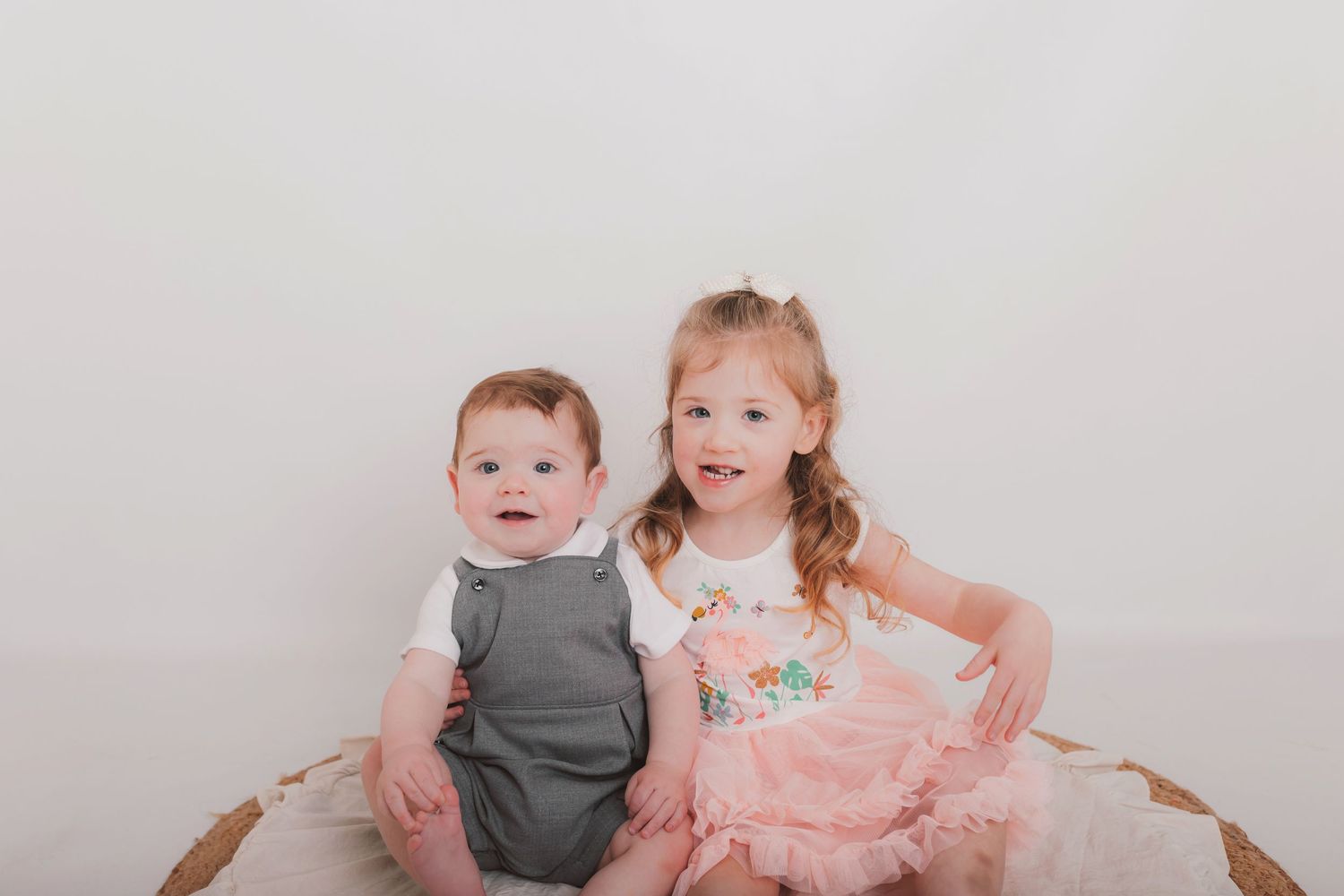 Children in coordinated outfits pose together during studio photo session. Photographer. Hull. East Yorkshire. Photography