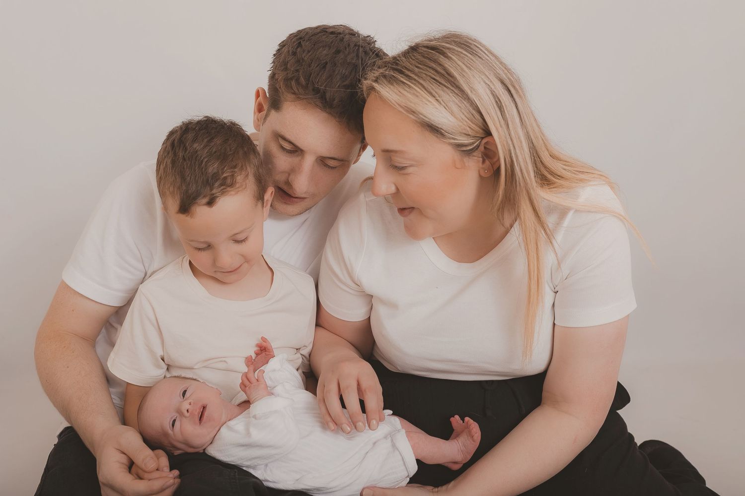 Series of tender family interactions in matching white outfits. Photographer. Hull. East Yorkshire. Photography