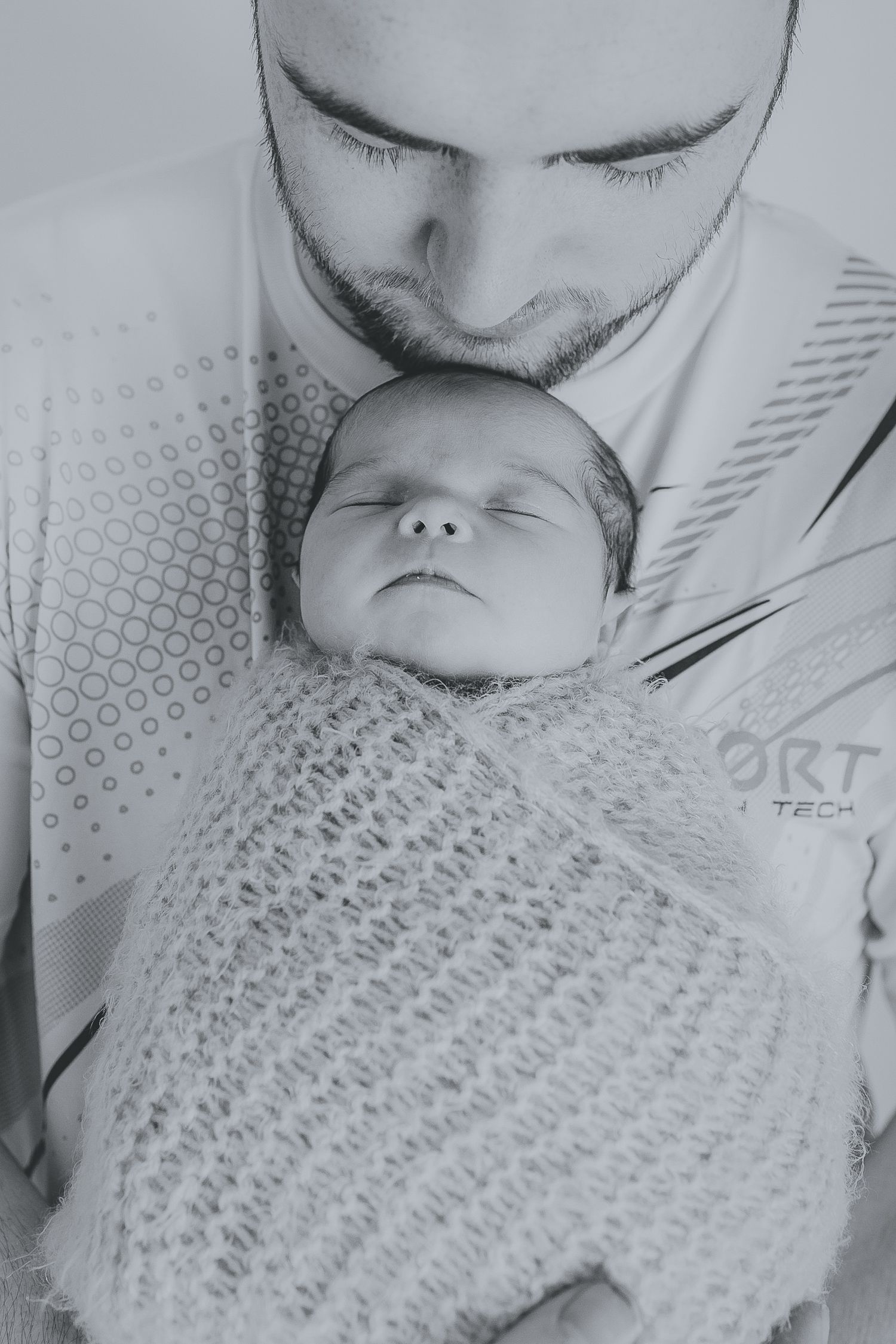 Black and white photo series showing tender moments with a newborn baby wrapped in knit blanket. Photographer. Hull. East Yorkshire. Photo