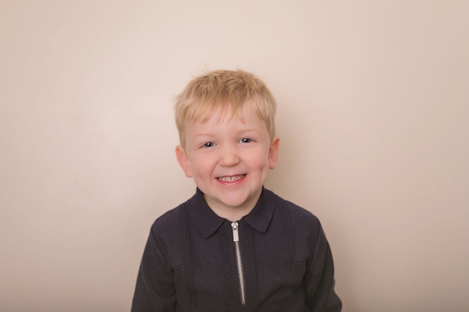 A candid portrait showing a bright smile against a neutral background. Photographer. Hull. East Yorkshire. Photography