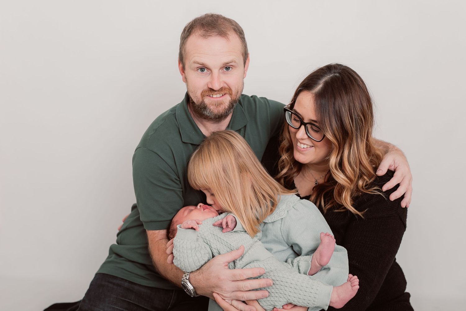 Family photo session showing loving interactions and embraces on white backdrop. Photographer. Hull. East Yorkshire. Photography