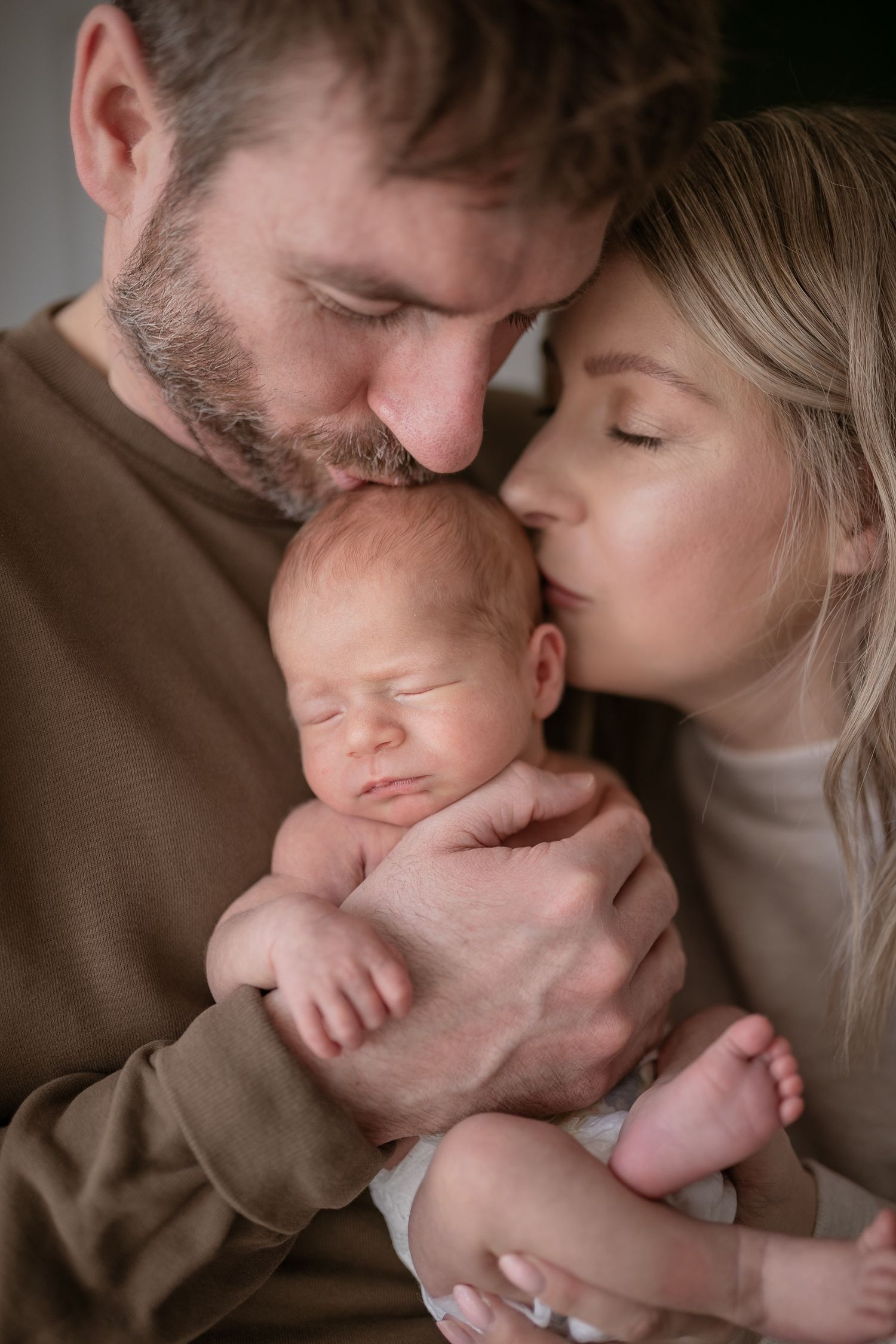 An intimate black and white portrait of new parents with their sleeping newborn. Photographer. Hull. East Yorkshire. Photography