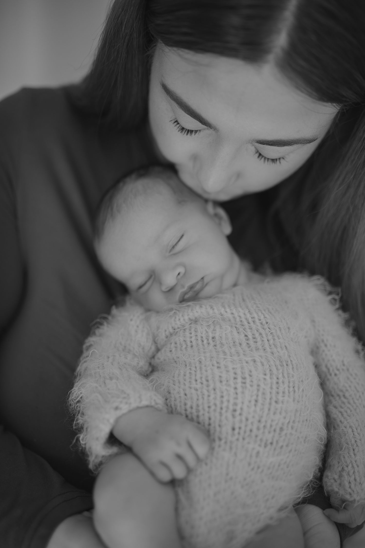 Intimate black and white portrait of mother cradling newborn baby. Photographer. Hull. East Yorkshire. Photography