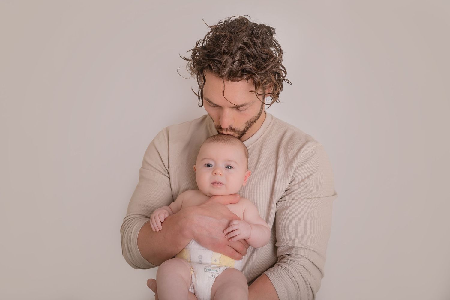 Artistic family portrait sequence showing intimate moments in muted beige tones. Photographer. Hull. East Yorkshire. Photography