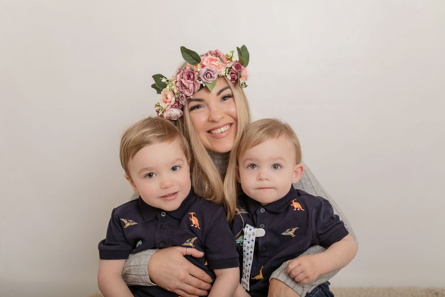 A joyful portrait featuring matching navy outfits and a pink floral crown. Photographer. Hull. East Yorkshire. Photography