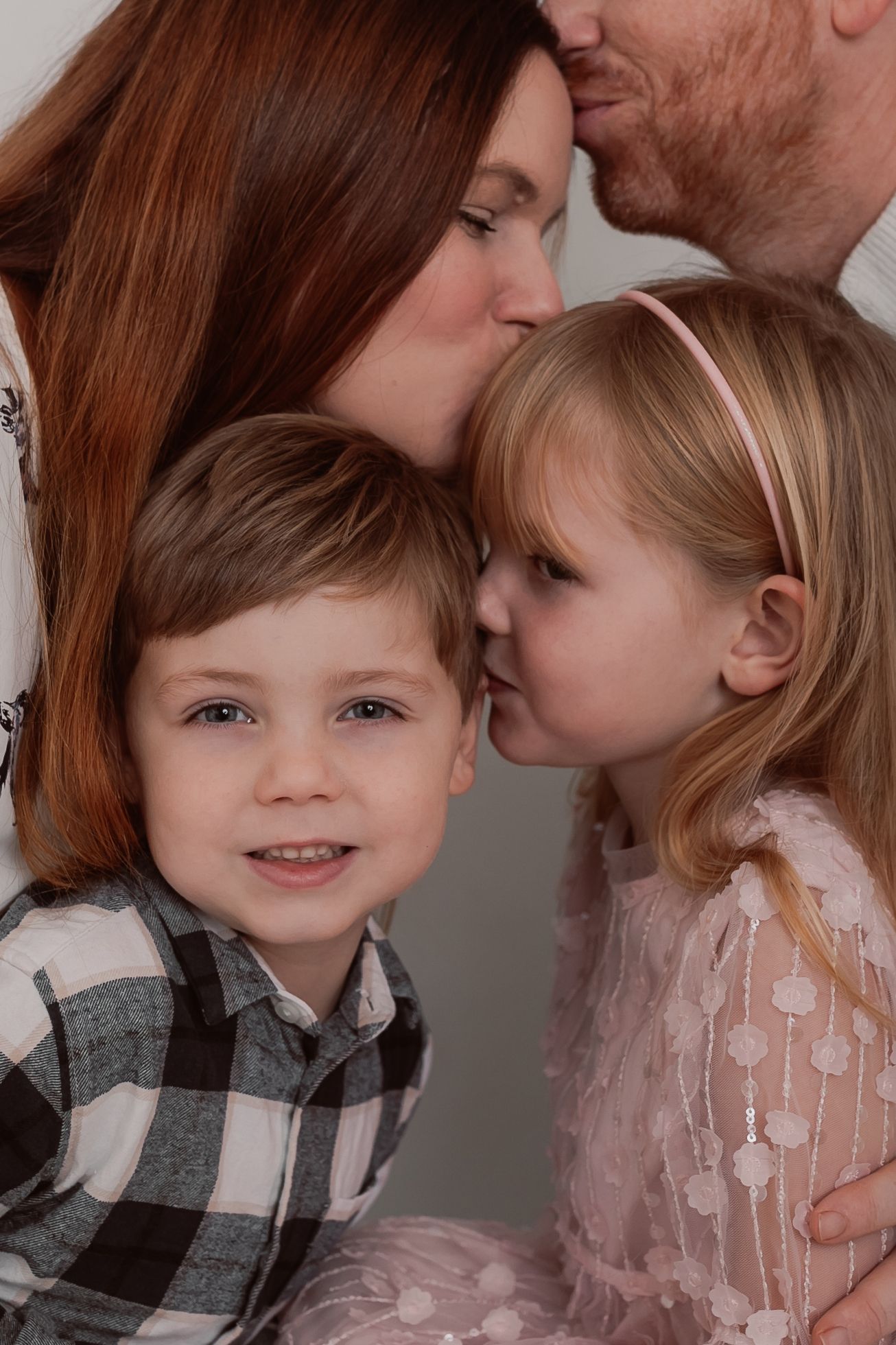 Intimate family portrait series showing loving interactions in soft studio lighting. Photographer. Hull. East Yorkshire. Photography