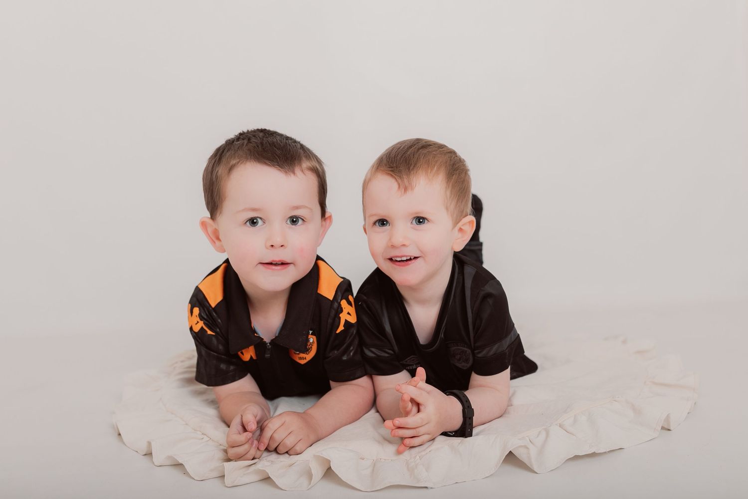 Professional studio photos of siblings in matching black outfits on white background. Photographer. Hull. East Yorkshire. Photography