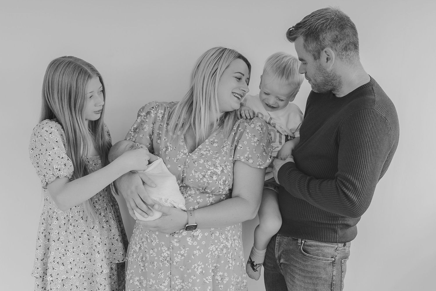 Monochrome family portraits showing loving interactions in a studio setting.  Photographer. Hull. East Yorkshire. Photography