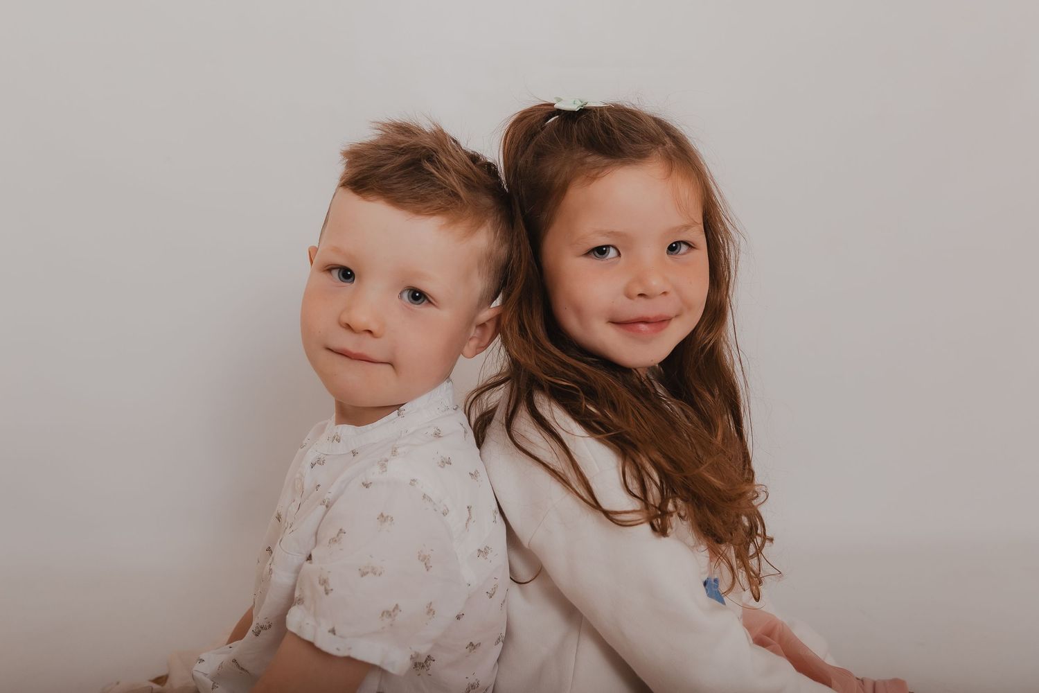 Two children cuddling and smiling together in a heartwarming moment. Photographer. Hull. East Yorkshire. Photography