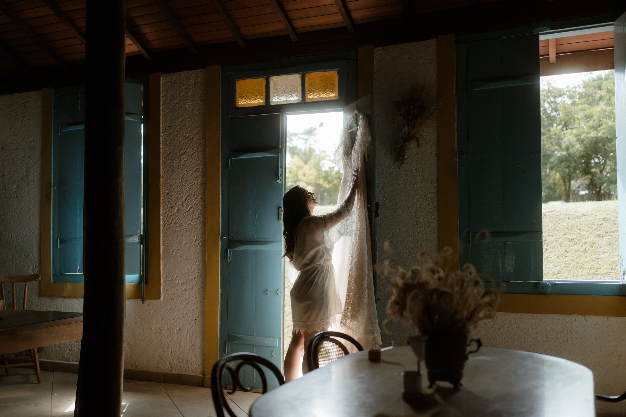 Interior of rustic venue space with natural light streaming through windows.