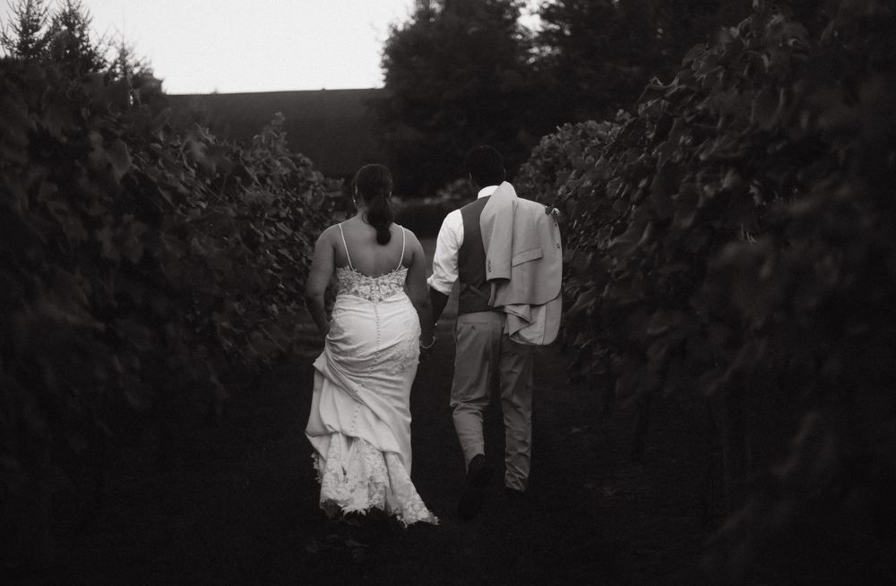 Romantic silhouettes walking through a garden path at twilight.