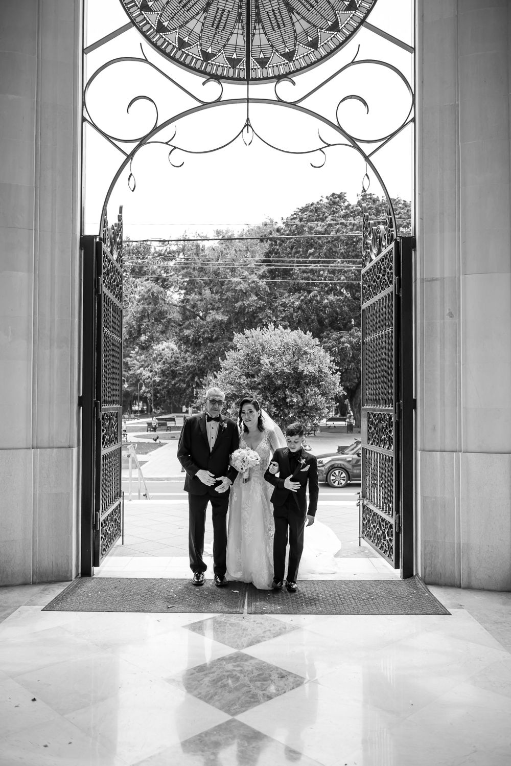 Black and white photo through ornate archway with decorative compass design.