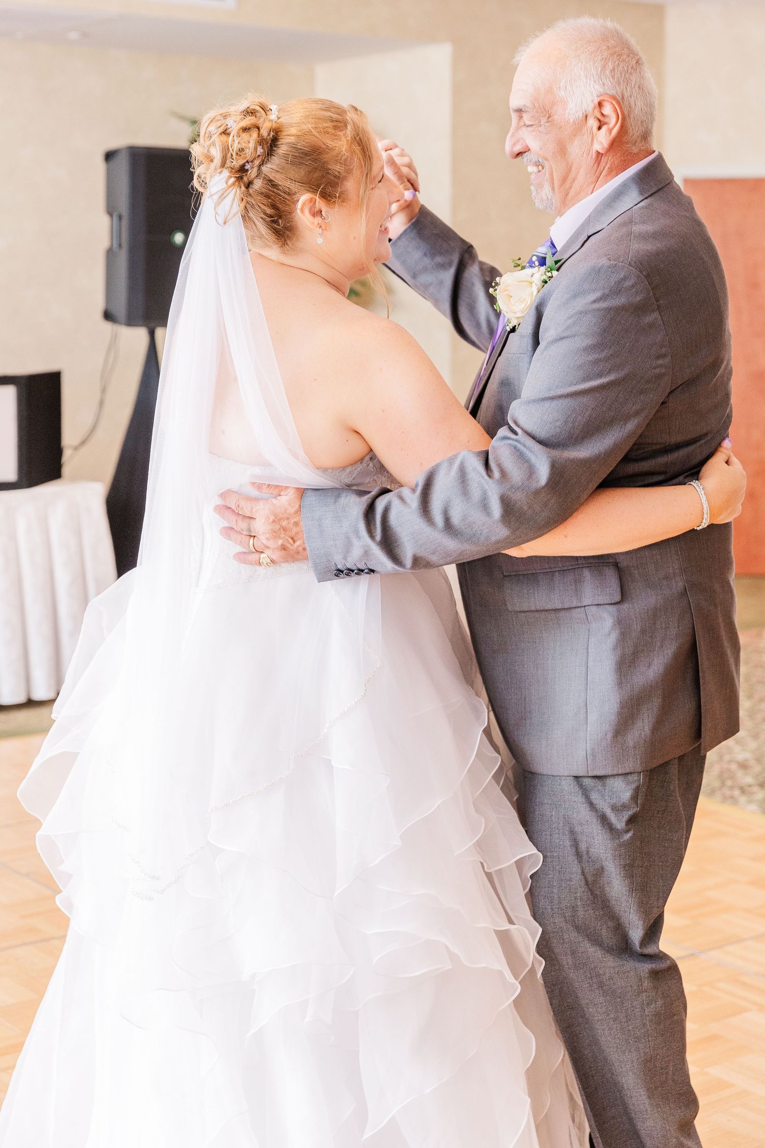 A touching dance moment between two people at a wedding celebration.