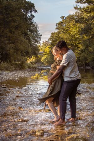 outdoor maternity session parents standing in the creek Etobicoke Pregnancy Photos